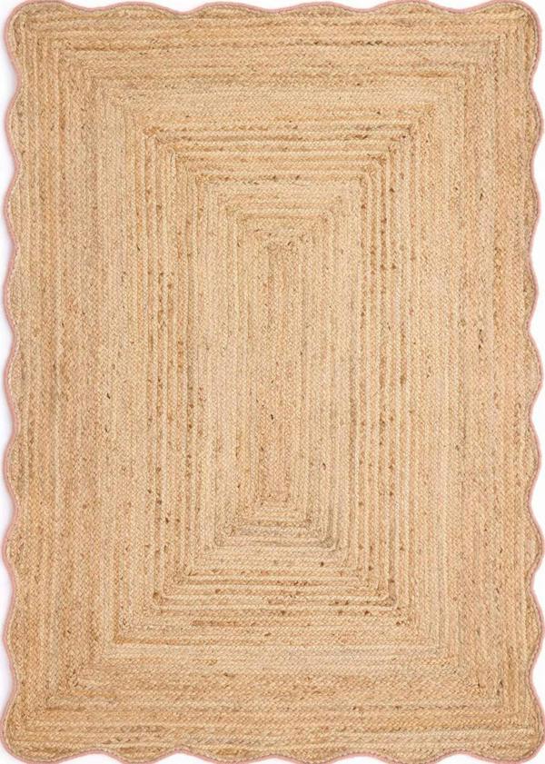 Beige braided rug with scalloped edge on a white background