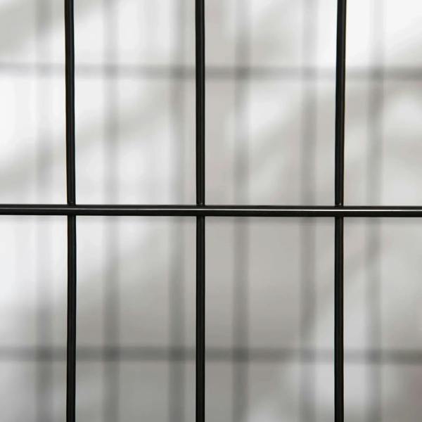 Close-up of black metal dog crate bars with grid pattern