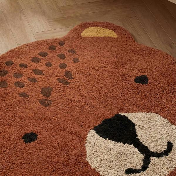 Round rug shaped like a bear on a wooden floor