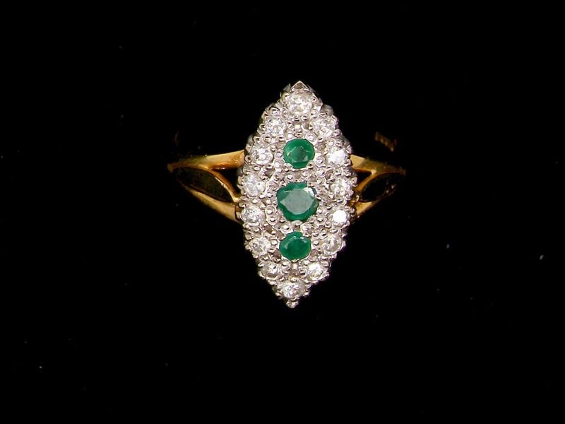 Vintage Tom An 18 carat gold emerald and diamond marquise shaped ring