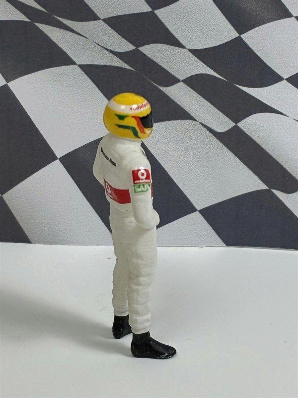 a toy figure of a race car driver