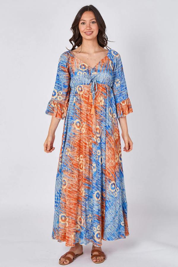 Woman wearing a blue and orange patterned dress on a white background