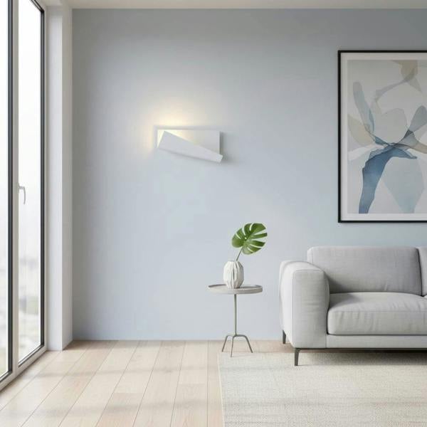 White modern wall sconce indoor on a pale blue coloured wall in a lounge area