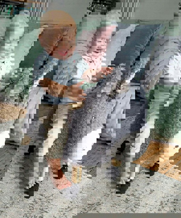 Little boy riding Bojangles Donkey Ride On Toy for toddlers with multidirectional castor wheels