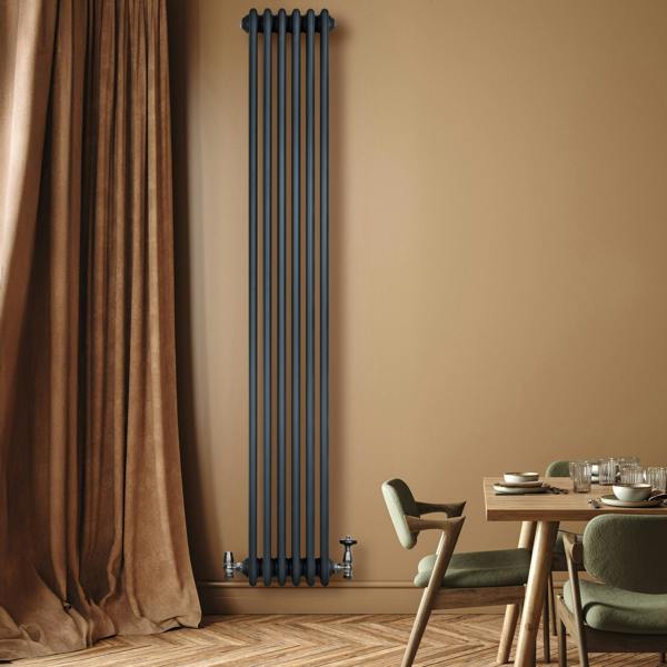 Traditional 4 column radiator in anthracite grey, sleek vertical design against a warm wall, enhancing modern interior decor