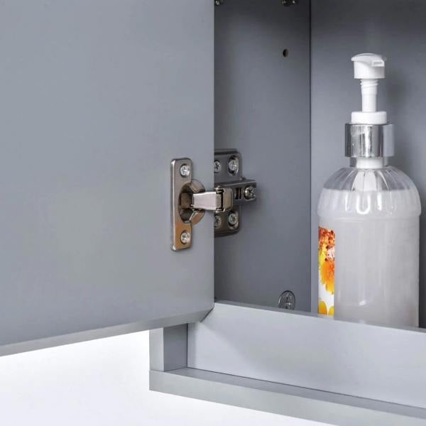 Grey cabinet door hinge and latch hardware next to inner shelf