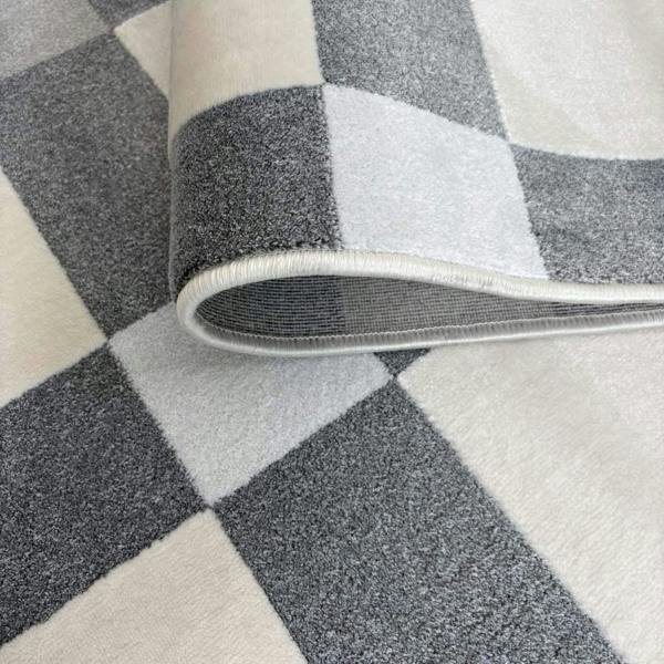 Roll of checkered patterned carpet with gray and white colors