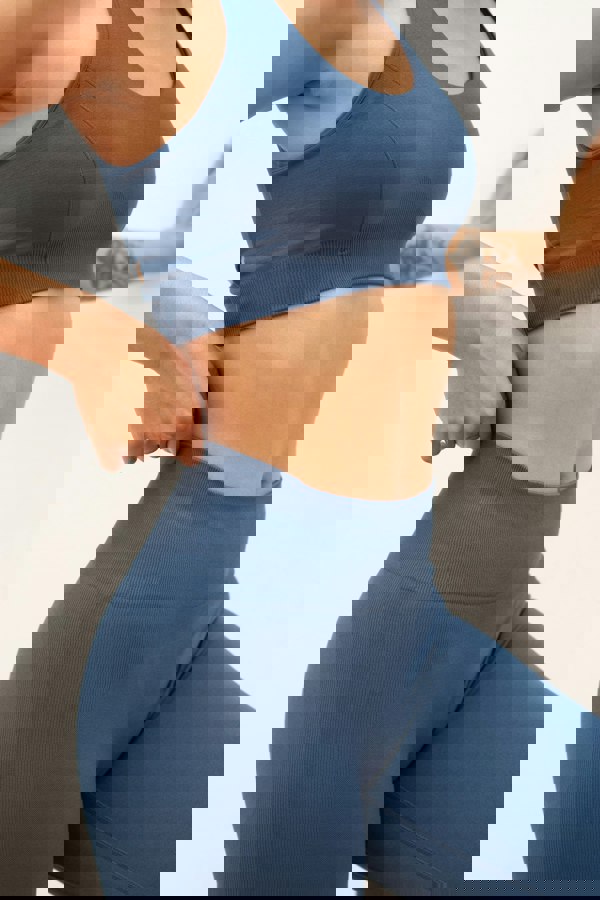 Blue recycled supportive sports bra and high waisted cropped leggings.