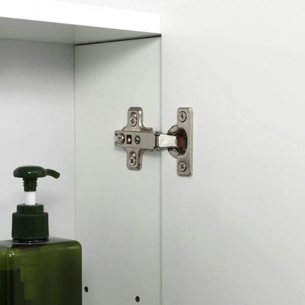 White mirror cabinet hinge and door latch hardware on cabinet door