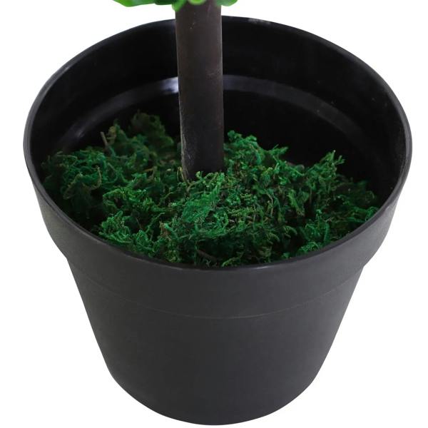Black pot with green moss and artificial plant trunk, close-up