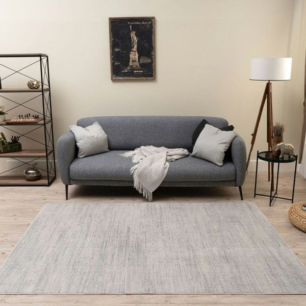 cream and grey rug features an abstract pattern