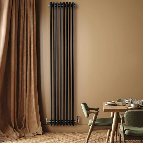 Traditional black 4 column radiator, 1800 x 380mm, featuring a sleek design against a warm beige wall, enhancing modern decor