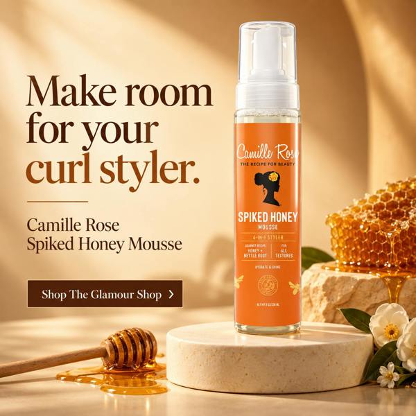 Camille Rose Spiked Honey Mousse bottle displayed on a stone pedestal with honeycomb, a honey dipper, and white flowers in a warm golden setting. Text on the left reads 'Make room for your curl stylister.