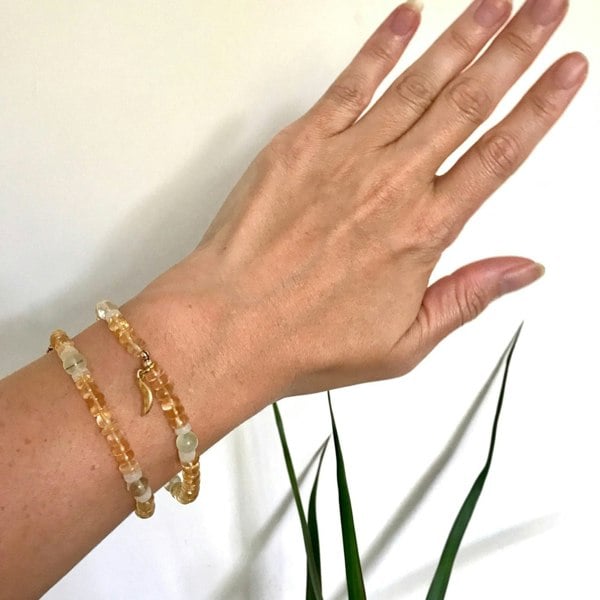 Kati Kaia citrine crystal bracelet worn on wrist with yellow and clear beads and gold charm