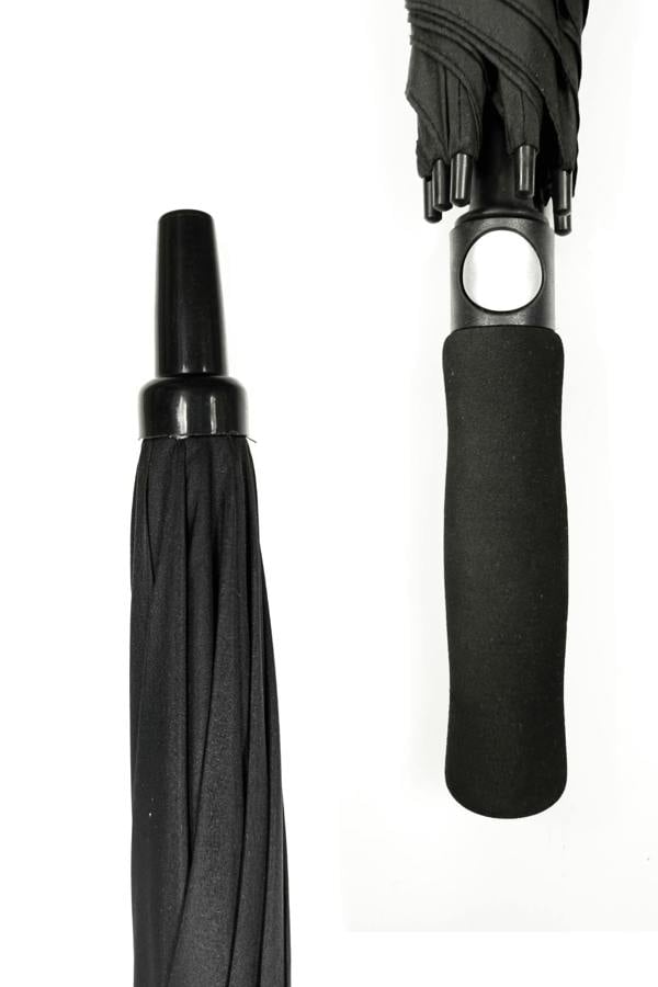 Close-up of black Optimum umbrella showing pointed tip and foam grip handle, on white - Optimum