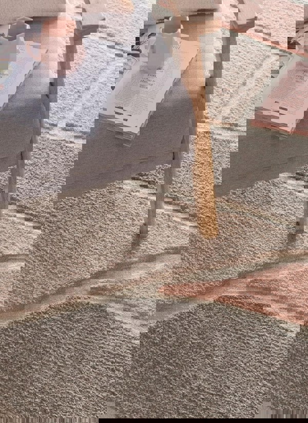 Strata Abstract Rug in soft pink and grey tones, featuring a deep pile, enhancing cozy home decor.