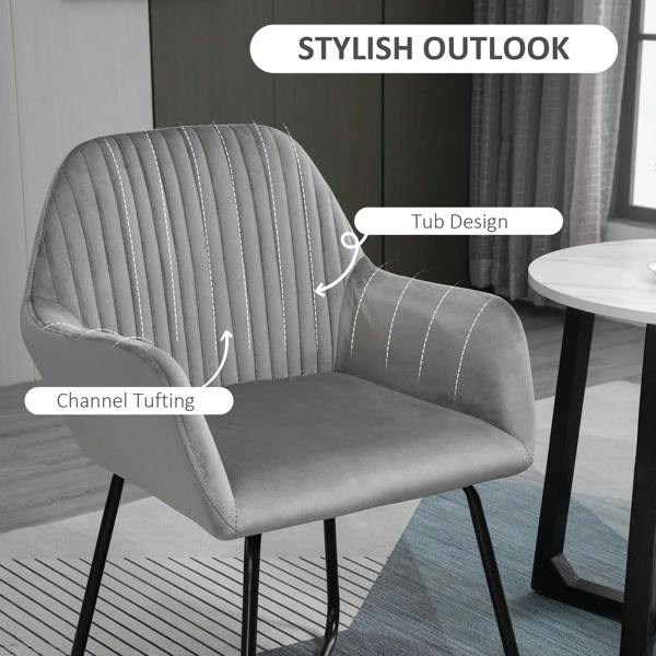 Grey upholstered arm chair with vertical channel tufting, rounded armrests, and metal legs