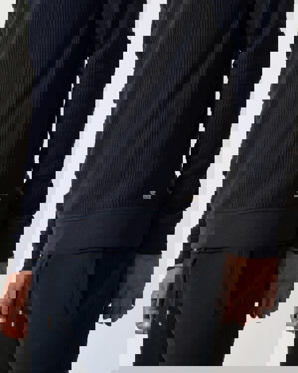 Detail shot of a Model wearing a BOSS Orange Structure Mens Loungewear Sweatshirt in Dark Blue