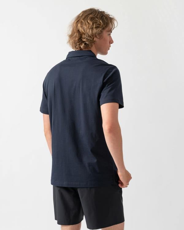 back shot of a model wearing an Emporio Armani Mens Beach Polo with Eagle Logo in Armani Blue
