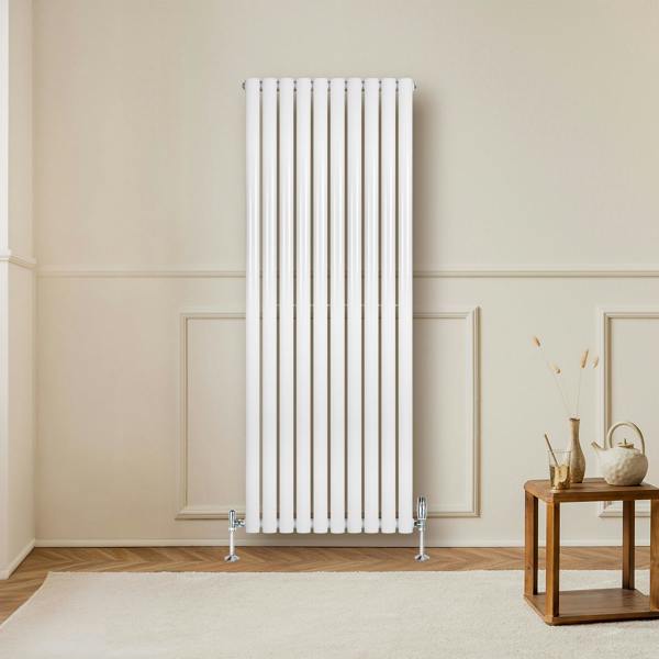 Sleek white oval single column radiator, 1600mm x 600mm, mounted on a wall, complemented by stylish valves and a cozy interior setting