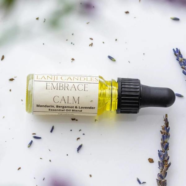Embrace Calm Mandarin Bergamot and Lavender Essential Oil Blend 10ml glass bottle with pipette lying among fresh lavender stalks by Abode Home & Gifts