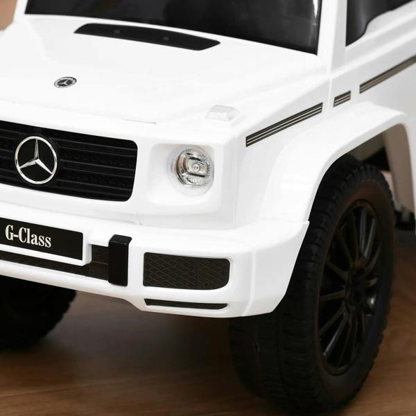 White kids ride-on car front with Mercedes-style grille, headlight, and black tires