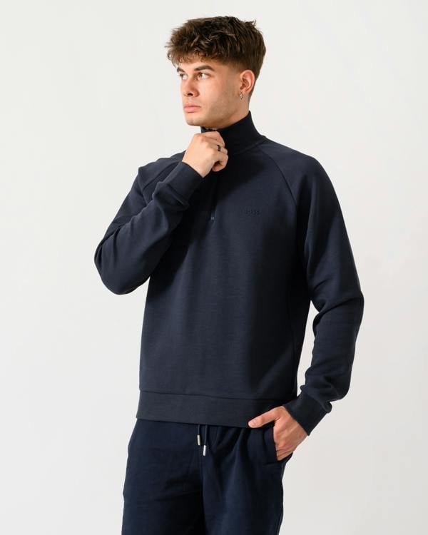 model wearing a BOSS Green Sweat Mens quarter Zip Sweatshirt in Dark Blue 402