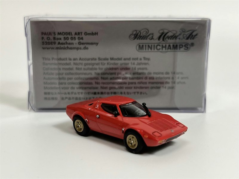 a red toy car in a plastic packaging