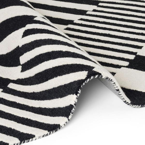 Close-up of a black and white striped rug with a zigzag pattern.
