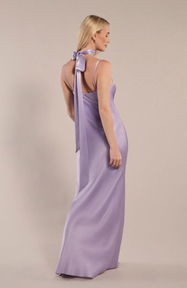 Model wearing cowl neck pollenca bridesmaids dress in lilac satin showing the back details.