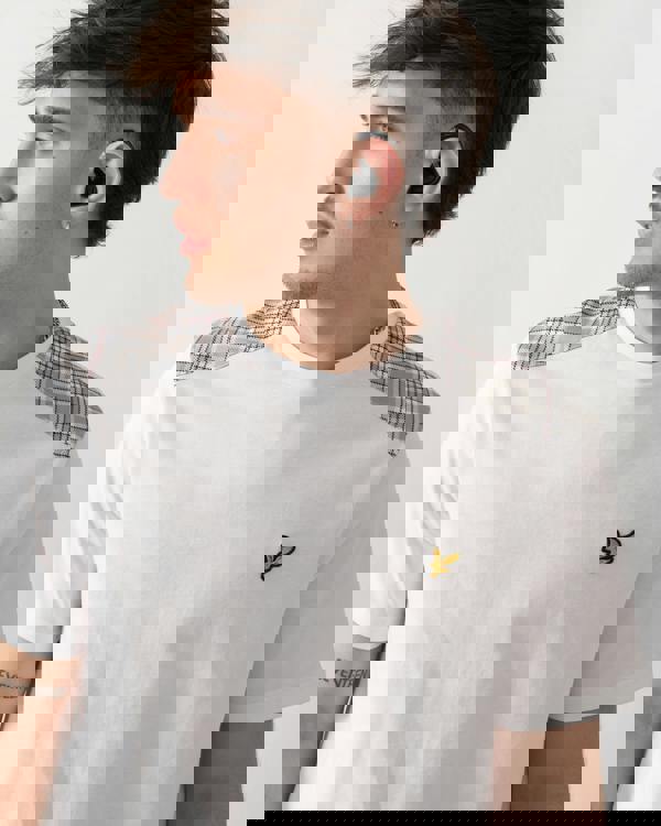 close up shot of a model wearing a Lyle & Scott Check Panelled Mens T-Shirt in 626 White