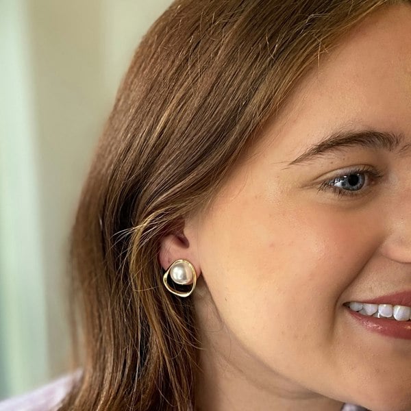 Pearl clip-on earrings, large round faux pearl centrepiece, irregular gold-tone open frame, modern vintage inspired jewellery, elegant statement accessory
