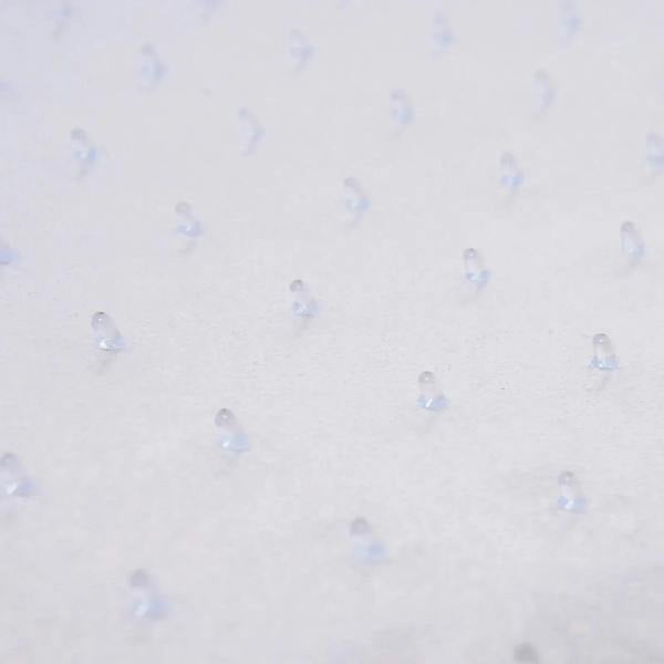 Close-up of clear chair mat with non-slip stud texture