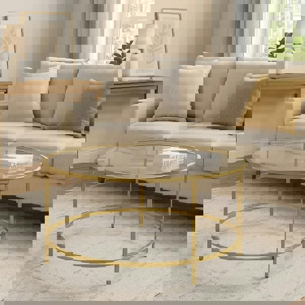 Modern round glass coffee table with gold metal frame for living room

