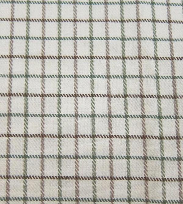 Close-up of Champion Ayr green check shirt fabric showing detailed weave and check pattern for a classic country look