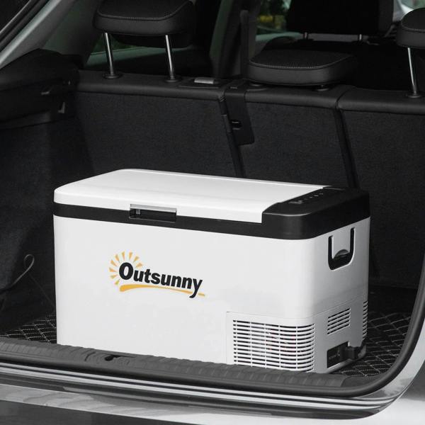White portable cooler with black lid and foldable handles, placed in a car trunk