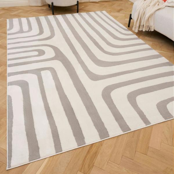 Gray and white geometric patterned rug on a wooden floor