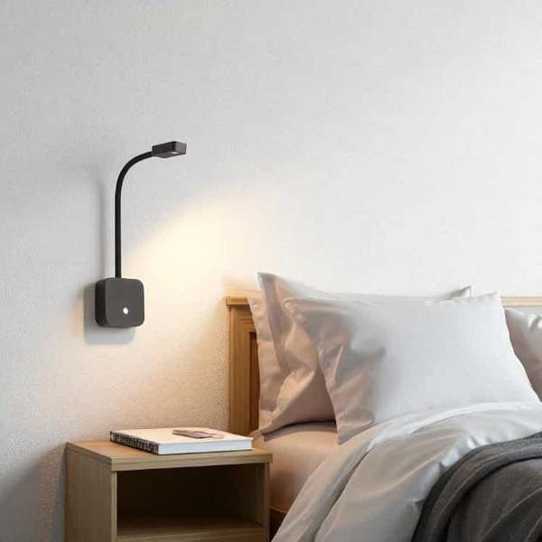 black bedroom reading light with USB ports installed in a modern bedroom next to the bed on the wall