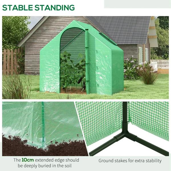 Green mini greenhouse with open door and corner frame with ground stakes.