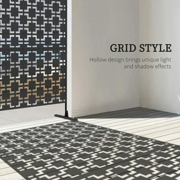 Black metal privacy screen divider with hollow geometric cutouts casting patterned shadows