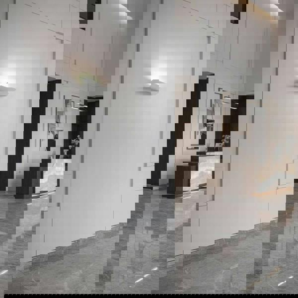 White indoor uplight wall light in the reception area of a hotel