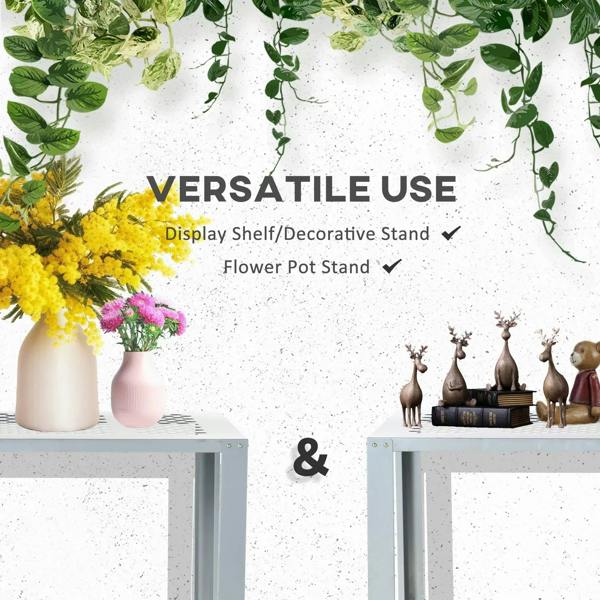 Silver steel plant stand with perforated shelf surfaces, shown as a decorative display.