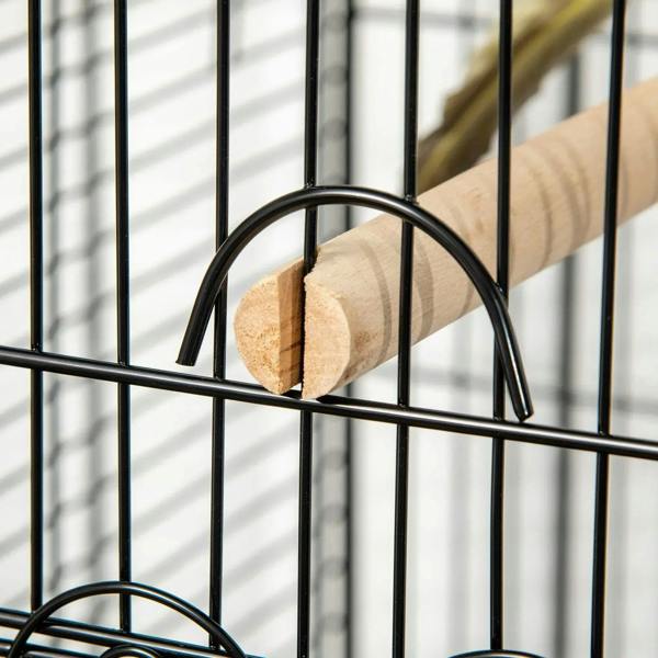 U-shaped perch bracket on black cage bars holding a wooden perch