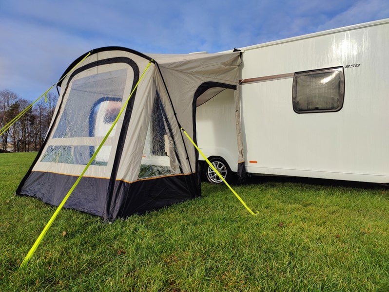 An image of the View Lite 260 Caravan Awning from OLPRO in a field attached to a caravan.