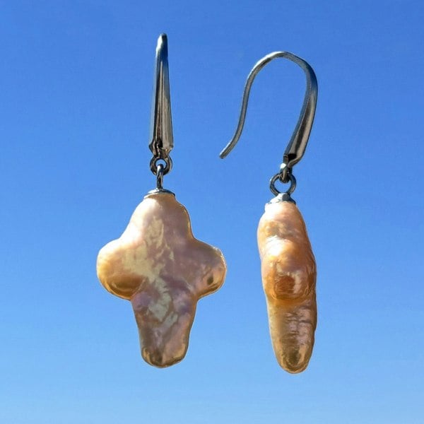 Cross-shaped baroque pearl earrings featuring unique celestial pearls, handcrafted in London.