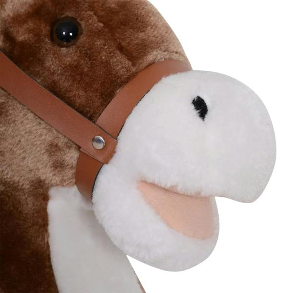 Plush white horse nose with brown harness strap on brown rocking horse