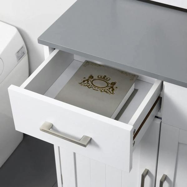 Single drawer of a white bathroom cabinet open, showing folded items inside