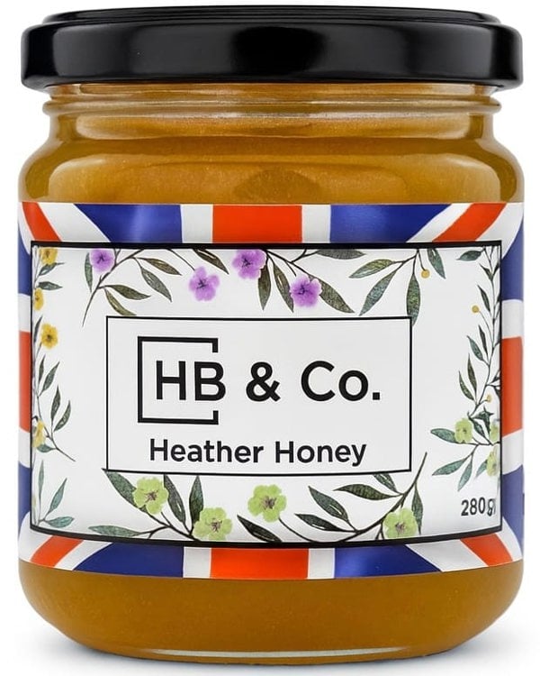 Jar of HoneyBee & Co. Heather Honey 280g with a deep amber colour and floral Union Jack label design.