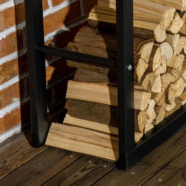 Black metal firewood rack base shelf holding stacked logs; close-up of frame.
