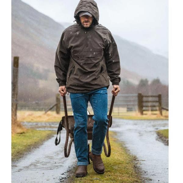 Gardener wearing the Hoggs of Fife Shire Pro waterproof dealer boots whilst pulling a wheelbarrow